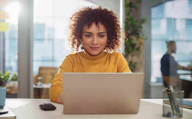 Vrouw werkt op haar laptop op kantoor